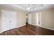 Bedroom with wood floors featuring a double door closet and access to the bathroom at 5159 Wellsley Bnd, Alpharetta, GA 30005
