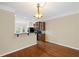 Dining area open to kitchen with hardwood floors, breakfast bar and ample natural light at 5159 Wellsley Bnd, Alpharetta, GA 30005