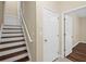 Hallway featuring a staircase and two doors at 5159 Wellsley Bnd, Alpharetta, GA 30005