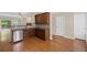 Modern kitchen with stainless steel dishwasher and open access to outdoor deck at 5159 Wellsley Bnd, Alpharetta, GA 30005