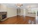 Open living area with hardwood floors, stone fireplace, and access to kitchen at 5159 Wellsley Bnd, Alpharetta, GA 30005