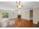 Open living area with hardwood floors, fireplace, and a view into the kitchen area at 5159 Wellsley Bnd, Alpharetta, GA 30005