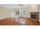 Living room with hardwood floors, stone fireplace, sliding glass doors, and ceiling fan at 5159 Wellsley Bnd, Alpharetta, GA 30005