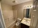 Cozy bathroom with shower-tub combo, tiled floors, and a vanity with a mirror at 6448 Charter Way, Lithonia, GA 30058