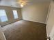 Spacious carpeted bedroom with two windows and a ceiling fan at 6448 Charter Way, Lithonia, GA 30058