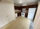 Kitchen featuring dark wood cabinets and white appliances next to a sliding glass door at 6448 Charter Way, Lithonia, GA 30058