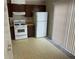 Basic kitchen with white appliances, wood cabinets and a window to the outside at 6448 Charter Way, Lithonia, GA 30058
