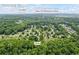 Neighborhood aerial view showcasing proximity of homes, trees, and Silver City Elementary School at 7920 Silversmith Dr, Cumming, GA 30028