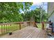 Wooden deck overlooks large backyard with mature trees providing plenty of shade at 7920 Silversmith Dr, Cumming, GA 30028