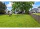Expansive backyard with lush lawn, a shed, a home, and perimeter fencing at 7920 Silversmith Dr, Cumming, GA 30028
