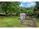 Well maintained backyard with lush lawn, shed, fencing, and mature trees at 7920 Silversmith Dr, Cumming, GA 30028