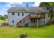 Expansive backyard with wooden deck, lush lawn, and a home with blue siding at 7920 Silversmith Dr, Cumming, GA 30028