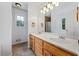 Bathroom featuring a double sink vanity with wood cabinets, tile flooring, and a large mirror at 7920 Silversmith Dr, Cumming, GA 30028