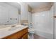 Bathroom featuring tile accents, a vanity sink, and a shower-tub combo at 7920 Silversmith Dr, Cumming, GA 30028