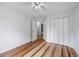 Bedroom with beautiful hardwood floors, ceiling fan, and ample closet space at 7920 Silversmith Dr, Cumming, GA 30028