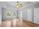 Spacious bedroom featuring tray ceilings, hardwood floors, and natural light at 7920 Silversmith Dr, Cumming, GA 30028