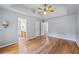 Bedroom with hardwood floors, grey walls, and view into the en-suite bathroom at 7920 Silversmith Dr, Cumming, GA 30028