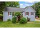 Charming one-story home featuring light blue siding, red shutters, and mature landscaping at 7920 Silversmith Dr, Cumming, GA 30028
