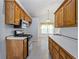 Galley kitchen with stainless steel appliances and wood cabinets at 7920 Silversmith Dr, Cumming, GA 30028