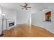 Bright living room with hardwood floors, a fireplace, and natural light at 7920 Silversmith Dr, Cumming, GA 30028