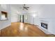 Bright living room with hardwood floors, a fireplace, and natural light at 7920 Silversmith Dr, Cumming, GA 30028