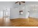 Open-concept living room with hardwood floors and lots of natural light at 7920 Silversmith Dr, Cumming, GA 30028