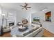 Staged living room featuring hardwood floors, fireplace, and a comfortable seating arrangement at 7920 Silversmith Dr, Cumming, GA 30028