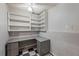 Basement office space with built-in desk, shelving, and checkered floors at 7920 Silversmith Dr, Cumming, GA 30028