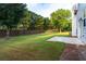Large backyard featuring a beautiful lawn and a concrete patio at 8750 Radford Ln, Suwanee, GA 30024