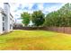 Large backyard featuring a beautiful lawn and a wood fence at 8750 Radford Ln, Suwanee, GA 30024