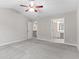 Large bedroom with neutral walls, plush carpet, a vaulted ceiling, and easy access to the ensuite bathroom at 8750 Radford Ln, Suwanee, GA 30024