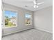 Well-lit bedroom featuring neutral walls, plush carpet, and two windows offering bright natural light at 8750 Radford Ln, Suwanee, GA 30024