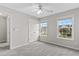 Inviting bedroom with neutral walls, plush carpet, two windows and a closet with natural light at 8750 Radford Ln, Suwanee, GA 30024