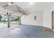 Open two-car garage with a blue floor, and an open garage door at 8750 Radford Ln, Suwanee, GA 30024
