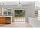 Bright kitchen with stainless steel dishwasher and sliding glass doors leading to the backyard at 8750 Radford Ln, Suwanee, GA 30024
