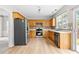 Well-lit kitchen with stainless steel appliances, light wood cabinets, and light-colored flooring at 8750 Radford Ln, Suwanee, GA 30024