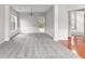 Bright and airy living room featuring grey carpet, white trim, and large windows leading to the outdoors at 8750 Radford Ln, Suwanee, GA 30024