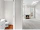 Modern living space offering a glimpse of the bathroom and fireplace extending into a well-lit Gathering area at 8750 Radford Ln, Suwanee, GA 30024