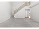 Bright living room with staircase, new carpet, and neutral paint at 8750 Radford Ln, Suwanee, GA 30024