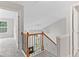 Staircase with wood and black iron railing, leading to the upper level at 8750 Radford Ln, Suwanee, GA 30024