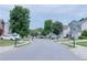 A shot of the neighborhood featuring a quiet street and well manicured lawns at 8750 Radford Ln, Suwanee, GA 30024