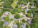 Aerial view of a neighborhood featuring mature trees with winding roads and manicured lawns at 125 Savannah Estates Dr, Atlanta, GA 30350