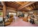 Unfinished basement with exposed wood beams, pink painted floor, and plenty of room for storage and potential customization at 125 Savannah Estates Dr, Atlanta, GA 30350