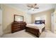 Bedroom with a wooden bed, dresser, mirror, fan and blue pillows at 125 Savannah Estates Dr, Atlanta, GA 30350