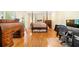 Bright bedroom featuring hardwood floors, a comfortable bed, and a classic desk at 125 Savannah Estates Dr, Atlanta, GA 30350