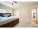 Bedroom with wooden bed frame and entry to the bathroom at 125 Savannah Estates Dr, Atlanta, GA 30350