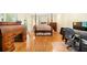Bedroom with hardwood floors, four-poster bed, and a workspace at 125 Savannah Estates Dr, Atlanta, GA 30350