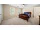 Bedroom with neutral walls, carpet, and wood furniture provides a calm, inviting space at 125 Savannah Estates Dr, Atlanta, GA 30350