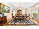 Elegant dining room with hardwood floors, a large table, and traditional decor at 125 Savannah Estates Dr, Atlanta, GA 30350