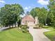 Well-manicured lawn surrounds a well-landscaped home with attached garage and basketball hoop at 125 Savannah Estates Dr, Atlanta, GA 30350